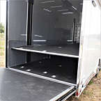 Rear view of interior one piece coin flooring, silver metal walls and carpet wainscoting